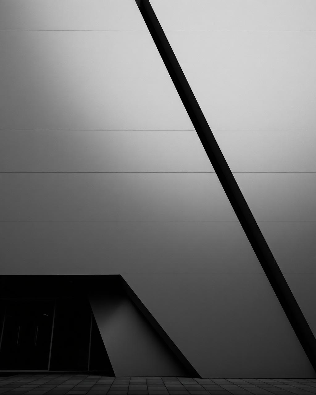 Abstract architectural facade with strong diagonal line and concrete planes